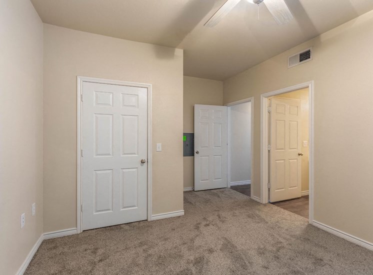 Bedroom with ceiling fan and wall to wall carpet